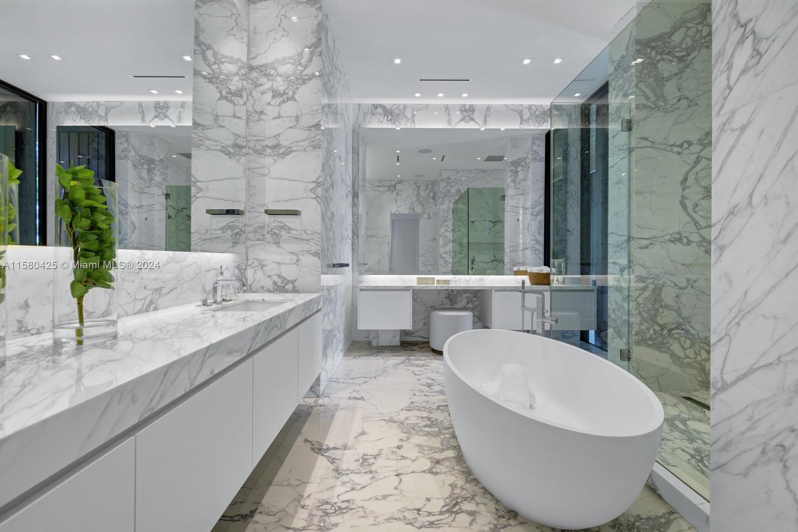 2700 Sunset Drive Miami Beach, FL 33140 - Photo 29 of 40 a bathroom with a double vanity sink mirror and bathtub