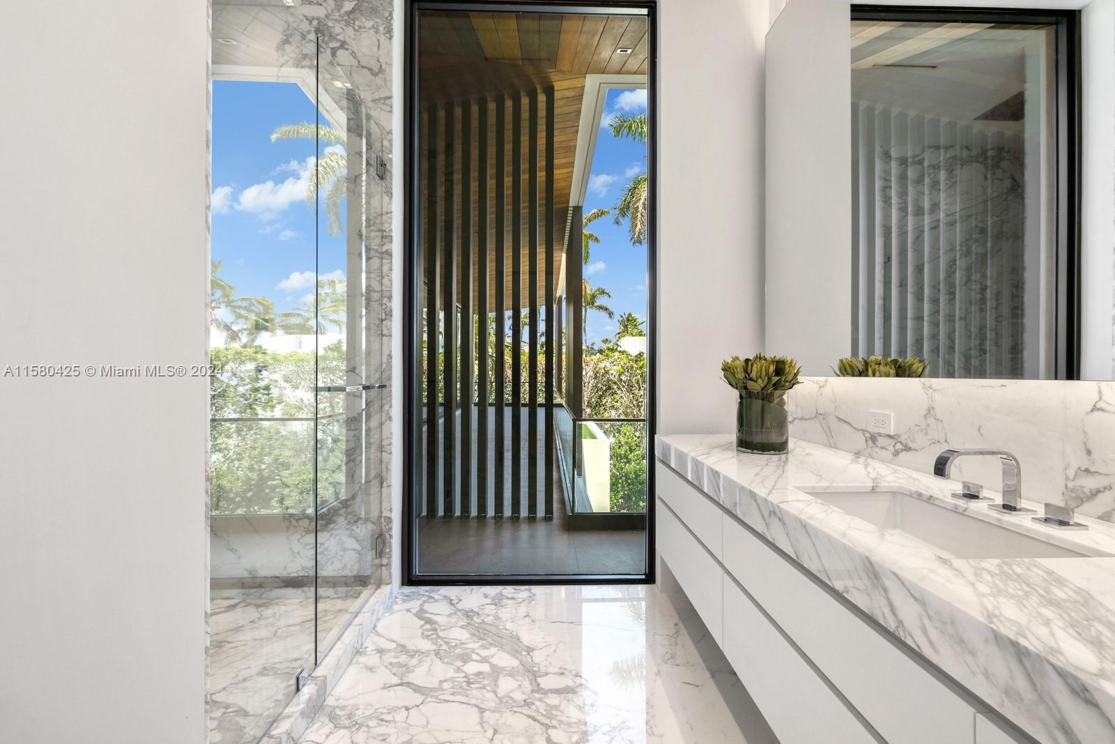 2700 Sunset Drive Miami Beach, FL 33140 - Photo 30 of 40 a bathroom with a granite countertop sink and a mirror