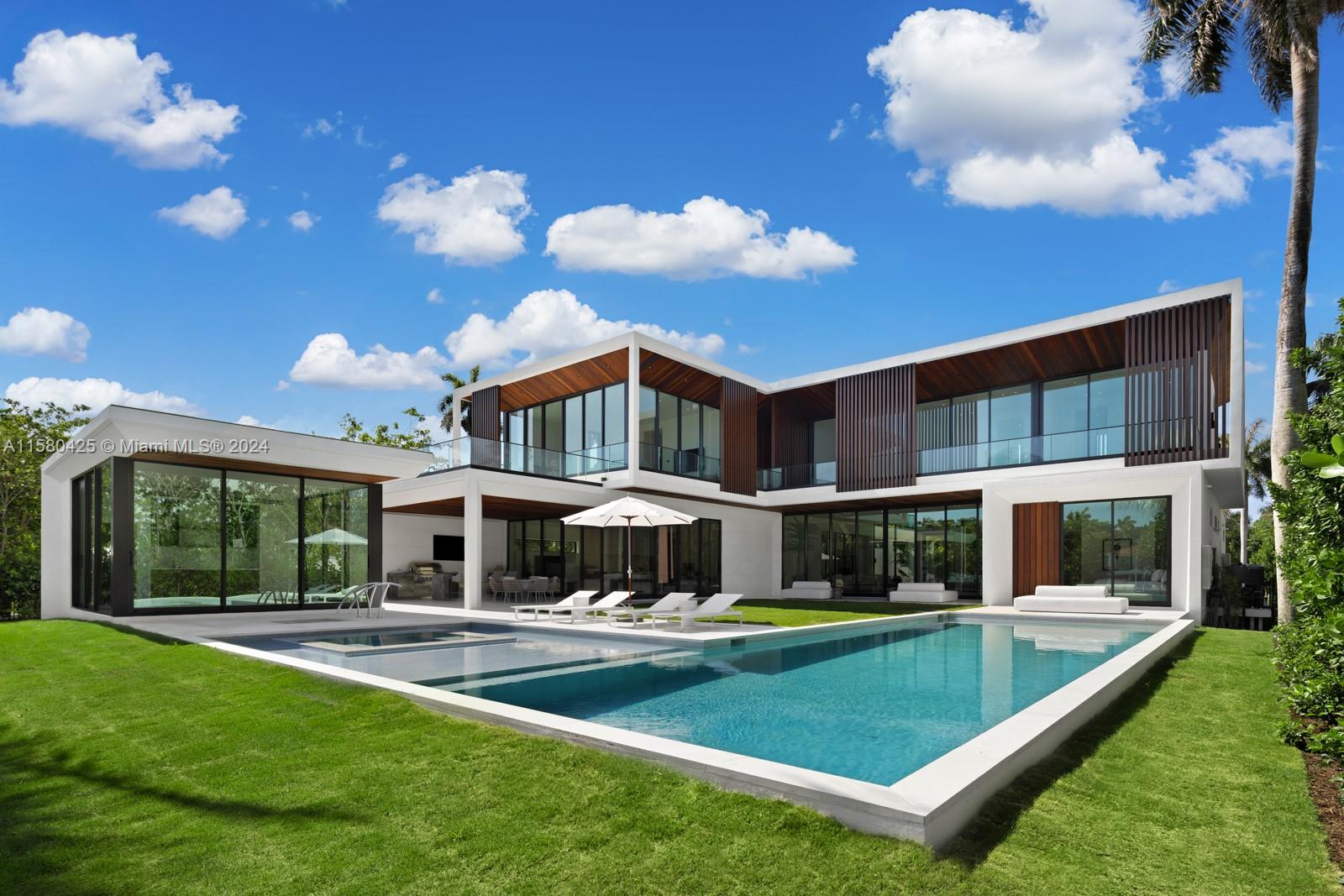 2700 Sunset Drive Miami Beach, FL 33140 - Photo 4 of 40 a view of a house with swimming pool and a yard