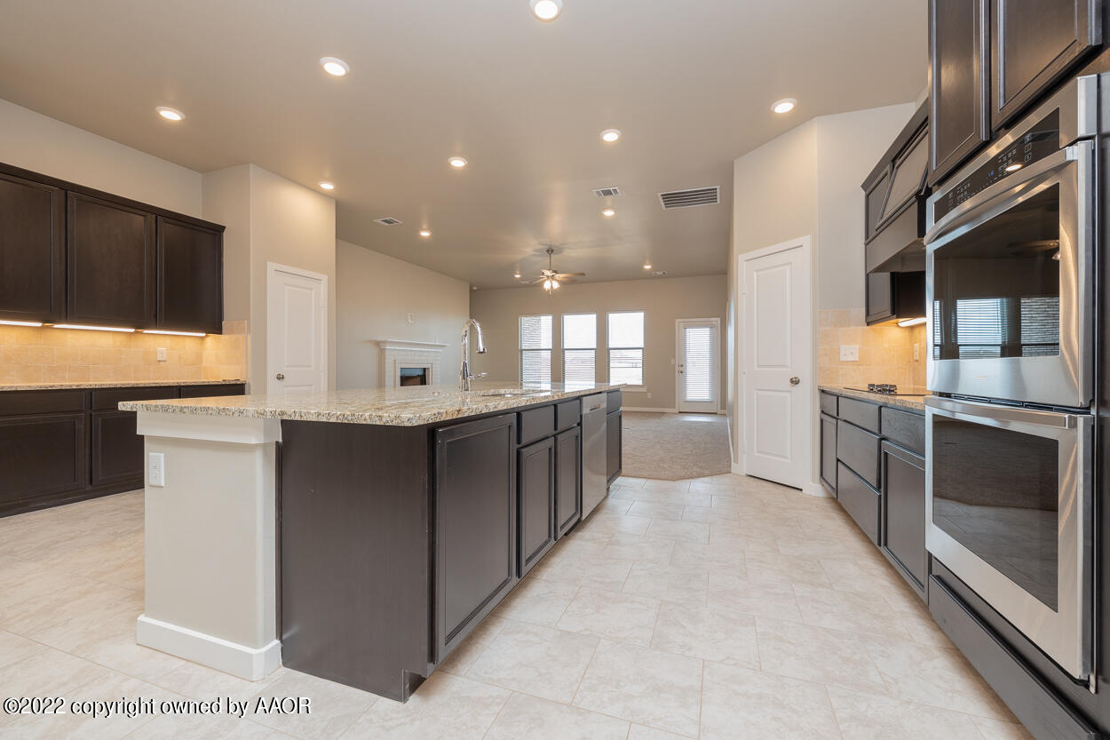 2600 Daybreak Lane Amarillo, TX 79124 - Photo 11 of 36 a large kitchen with a large counter top a sink stainless steel appliances and cabinets