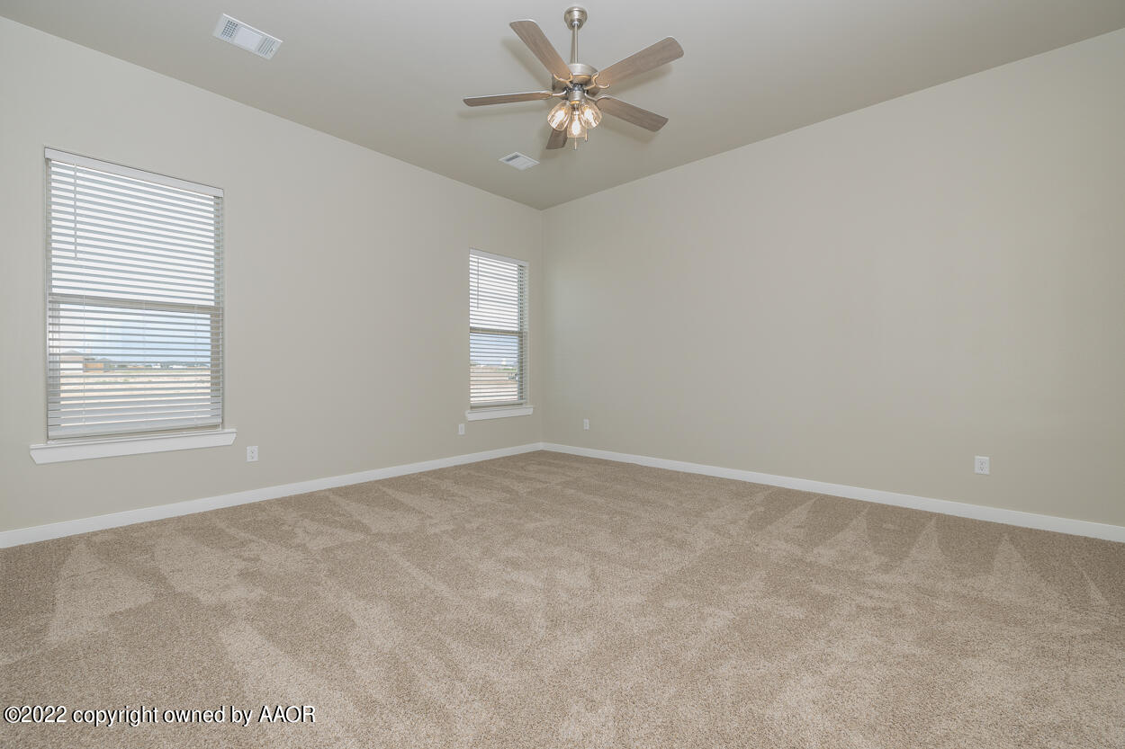 2600 Daybreak Lane Amarillo, TX 79124 - Photo 15 of 36 an empty room with windows and fan