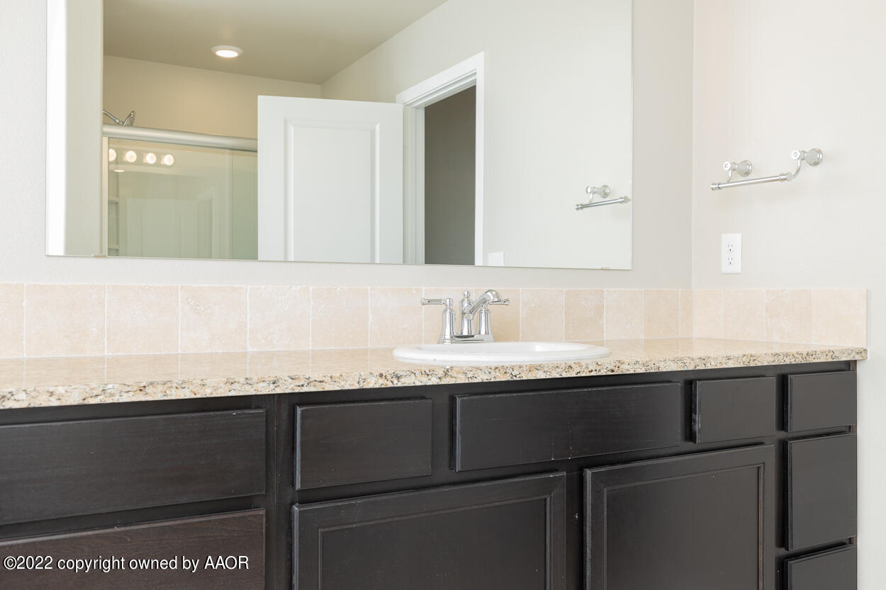 2600 Daybreak Lane Amarillo, TX 79124 - Photo 18 of 36 a bathroom with a granite countertop sink and a mirror