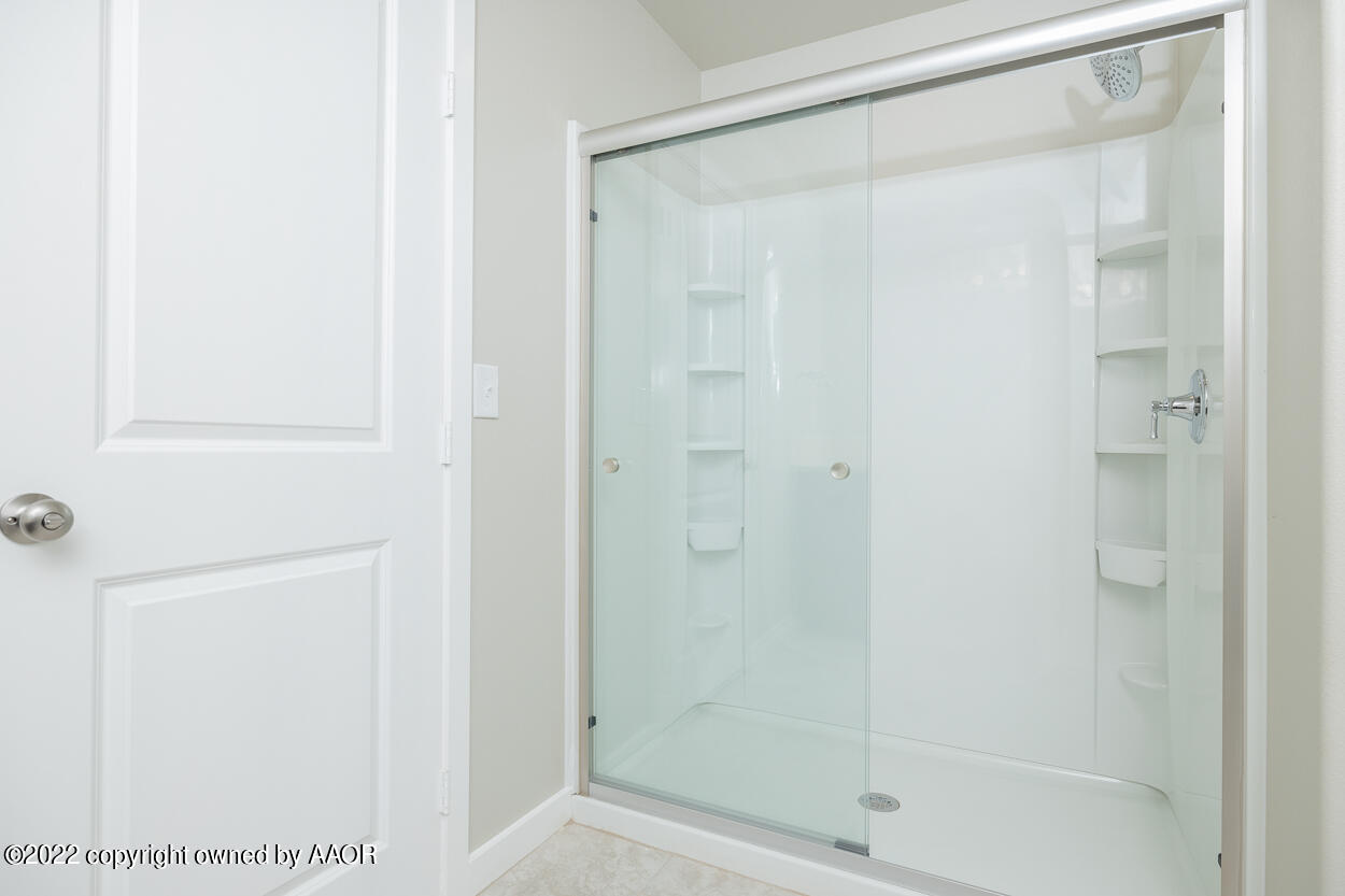 2600 Daybreak Lane Amarillo, TX 79124 - Photo 19 of 36 a bathroom with a glass shower door