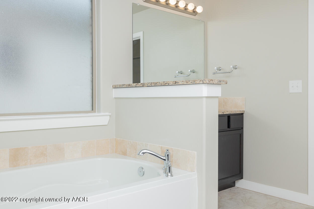 2600 Daybreak Lane Amarillo, TX 79124 - Photo 22 of 36 a bathroom with a bathtub and a sink