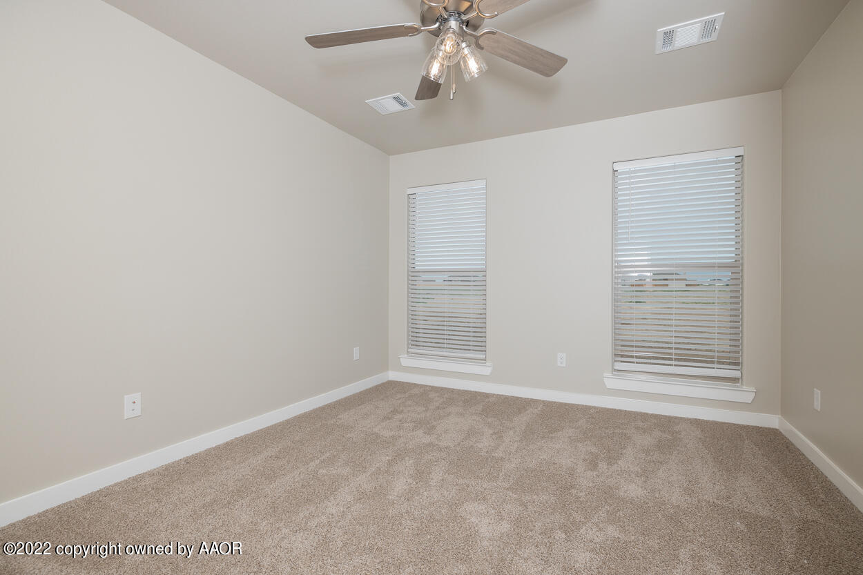 2600 Daybreak Lane Amarillo, TX 79124 - Photo 27 of 36 an empty room with windows and fan