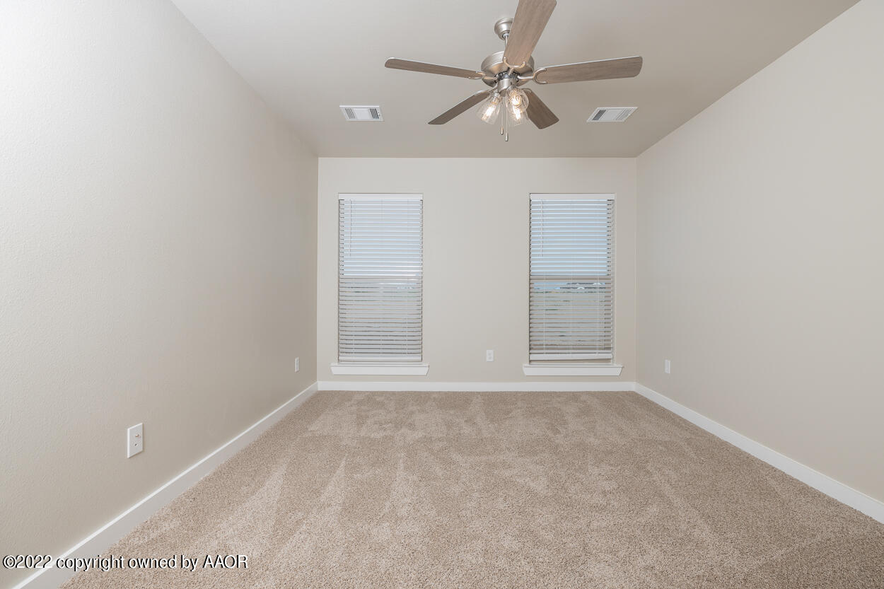 2600 Daybreak Lane Amarillo, TX 79124 - Photo 28 of 36 an empty room with a ceiling fan and a window