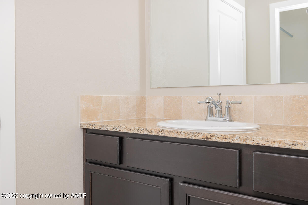 2600 Daybreak Lane Amarillo, TX 79124 - Photo 29 of 36 a bathroom with a granite countertop sink and a mirror