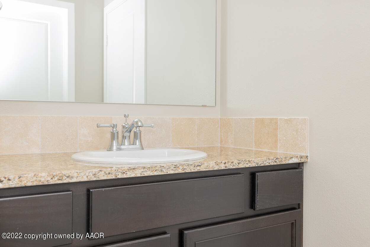2600 Daybreak Lane Amarillo, TX 79124 - Photo 31 of 36 a bathroom with a granite countertop sink and a mirror