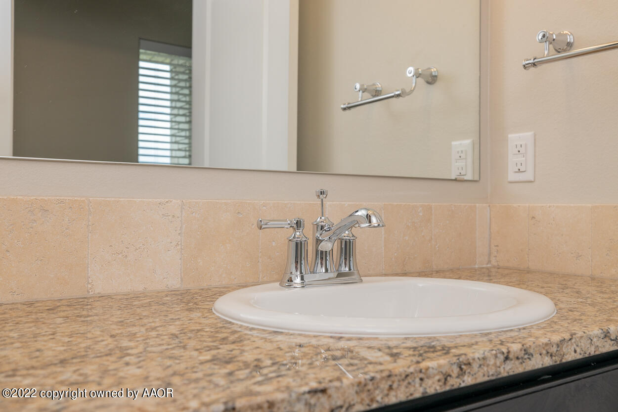 2600 Daybreak Lane Amarillo, TX 79124 - Photo 35 of 36 a bathroom with a sink and a mirror