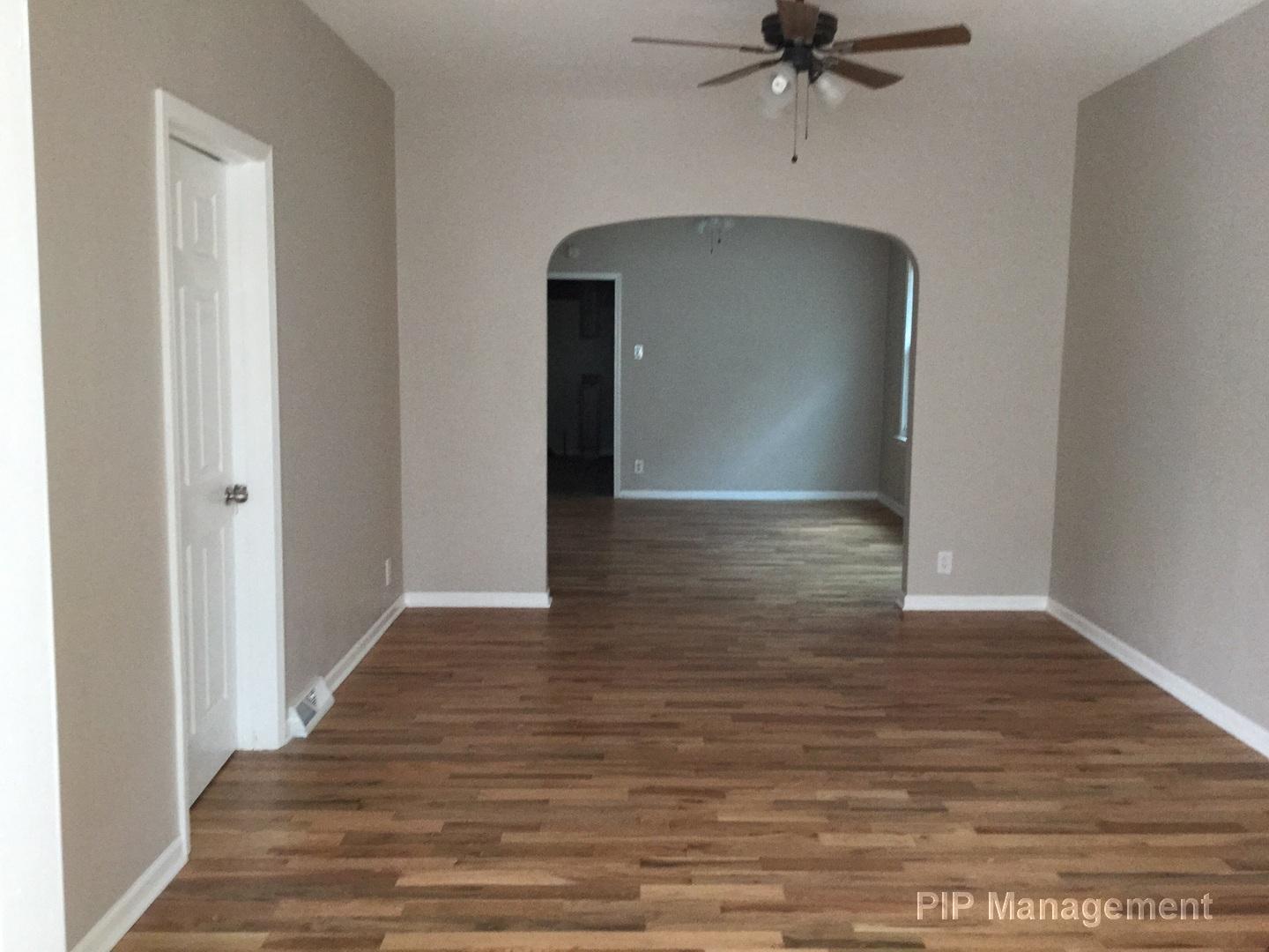 140 West 110th Street Chicago, IL 60628 - Photo 3 of 7 a view of a hallway with wooden floor and a ceiling fan