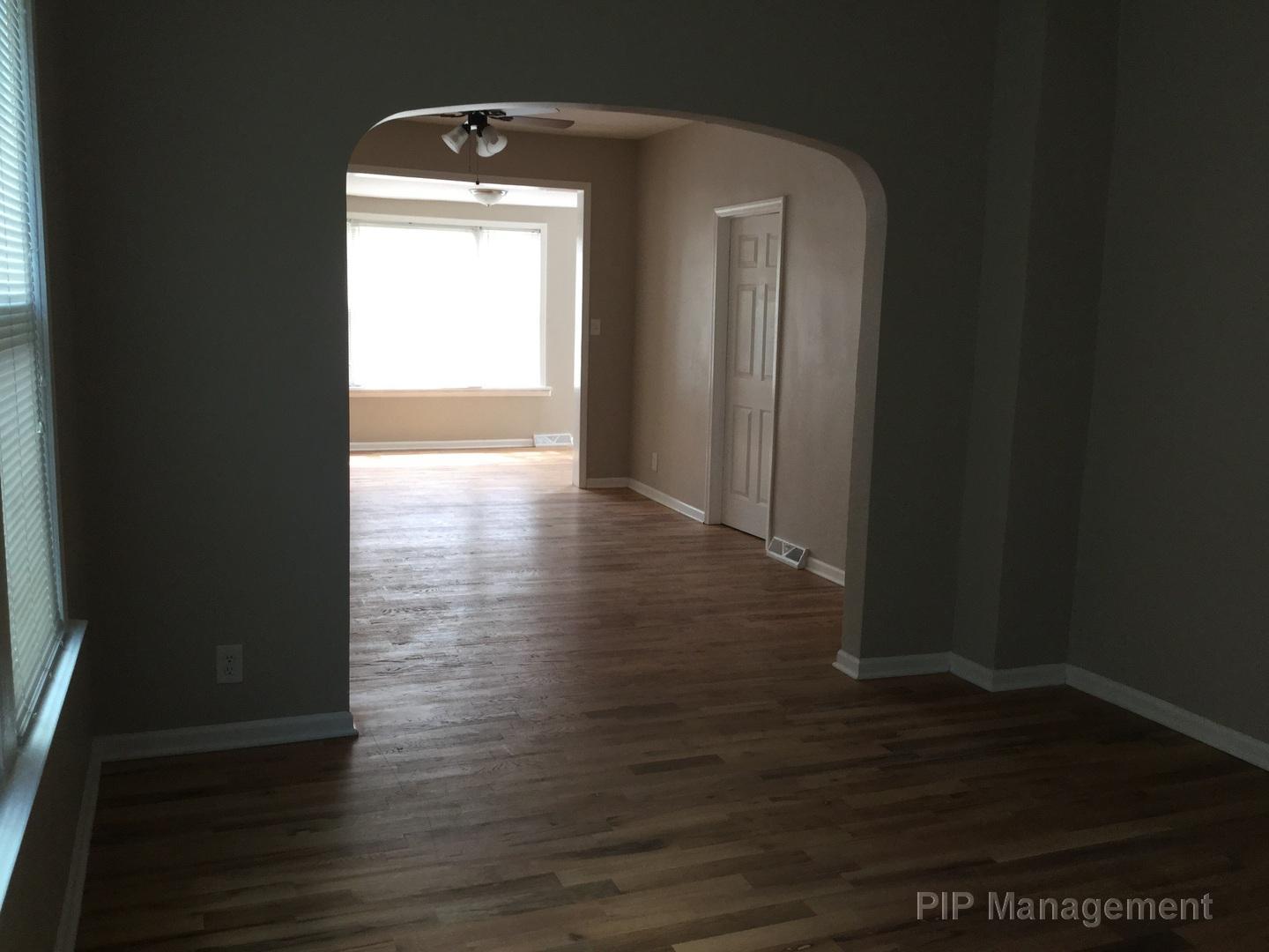 140 West 110th Street Chicago, IL 60628 - Photo 4 of 7 a view of a hallway with wooden floor and a window