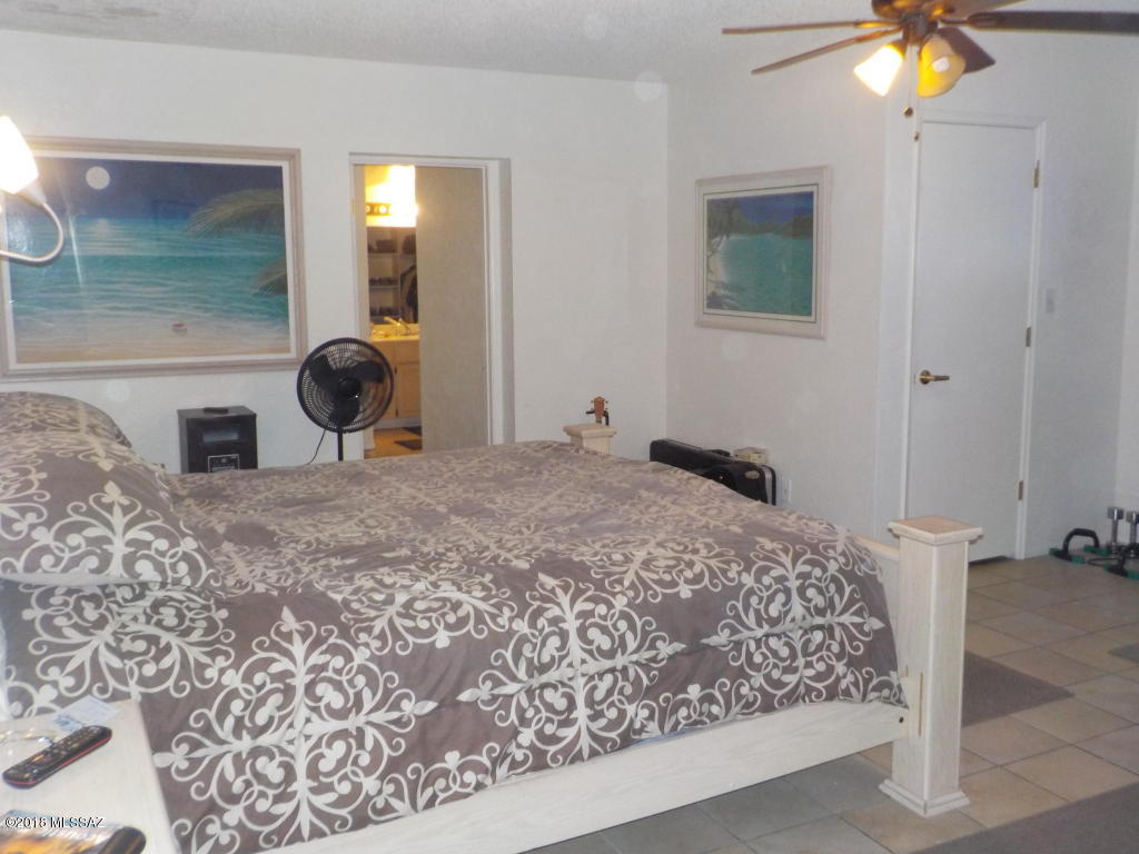 1215 Circulo Aguilar Rio Rico, AZ 85648 - Photo 8 of 12 a bedroom with a bed and a chandelier