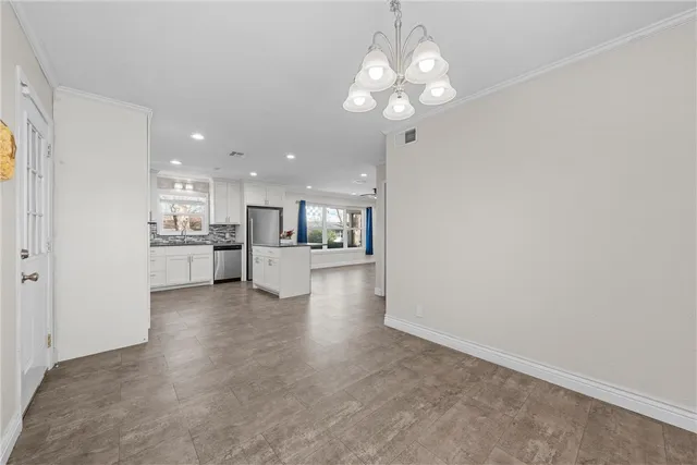 a view of kitchen with refrigerator and window