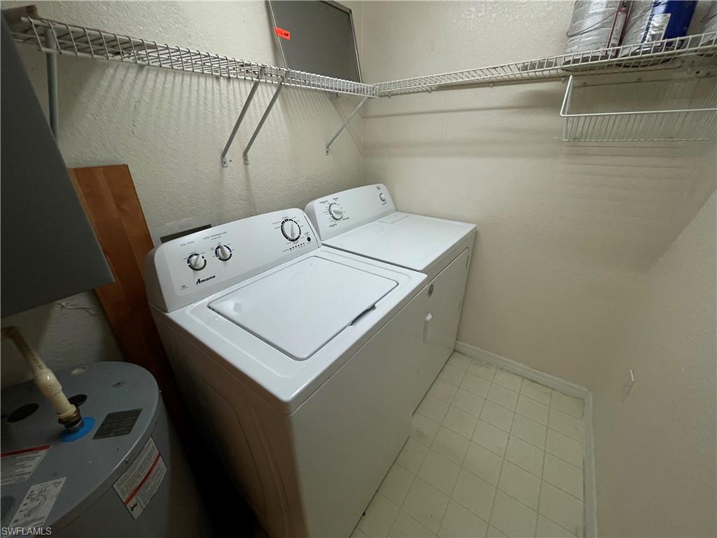 8274 Key Royal Circle, Unit 1032 Naples, FL 34119 - Photo 11 of 16 a utility room with dryer and washer