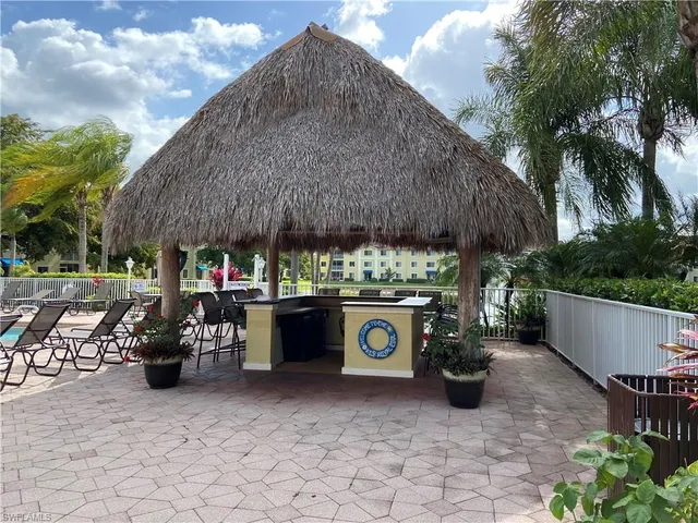 a couple of table and chairs in backyard of the house