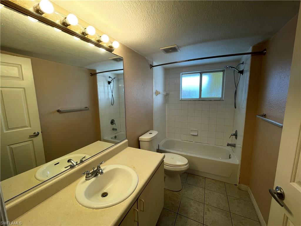8274 Key Royal Circle, Unit 1032 Naples, FL 34119 - Photo 8 of 16 a bathroom with a sink a toilet and shower