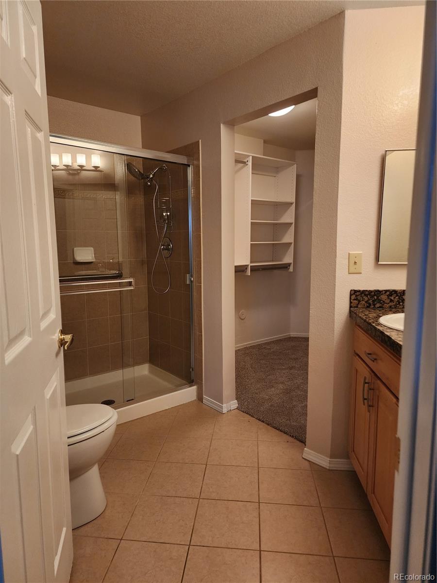 8601 East Dry Creek Road, Unit 112 Centennial, CO 80112 - Photo 14 of 19 a bathroom with a shower and a toilet