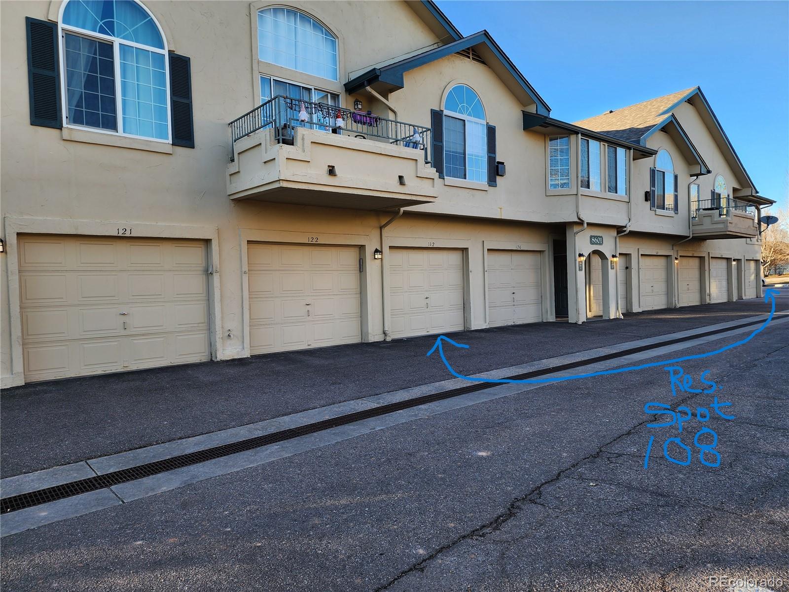8601 East Dry Creek Road, Unit 112 Centennial, CO 80112 - Photo 3 of 19 a white building with a outdoor space