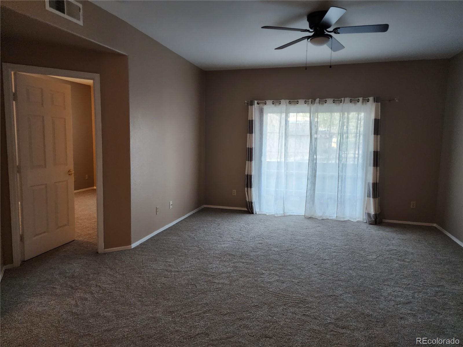 8601 East Dry Creek Road, Unit 112 Centennial, CO 80112 - Photo 7 of 19 an empty room with windows and fan