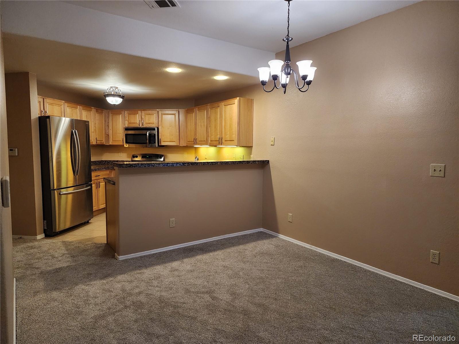 8601 East Dry Creek Road, Unit 112 Centennial, CO 80112 - Photo 8 of 19 a view of a kitchen with a sink and refrigerator
