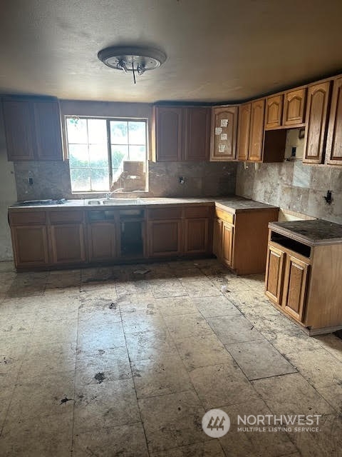 12201 Highway 12 Rochester, WA 98579 - Photo 10 of 18 a kitchen with granite countertop a stove a sink and a granite counter tops