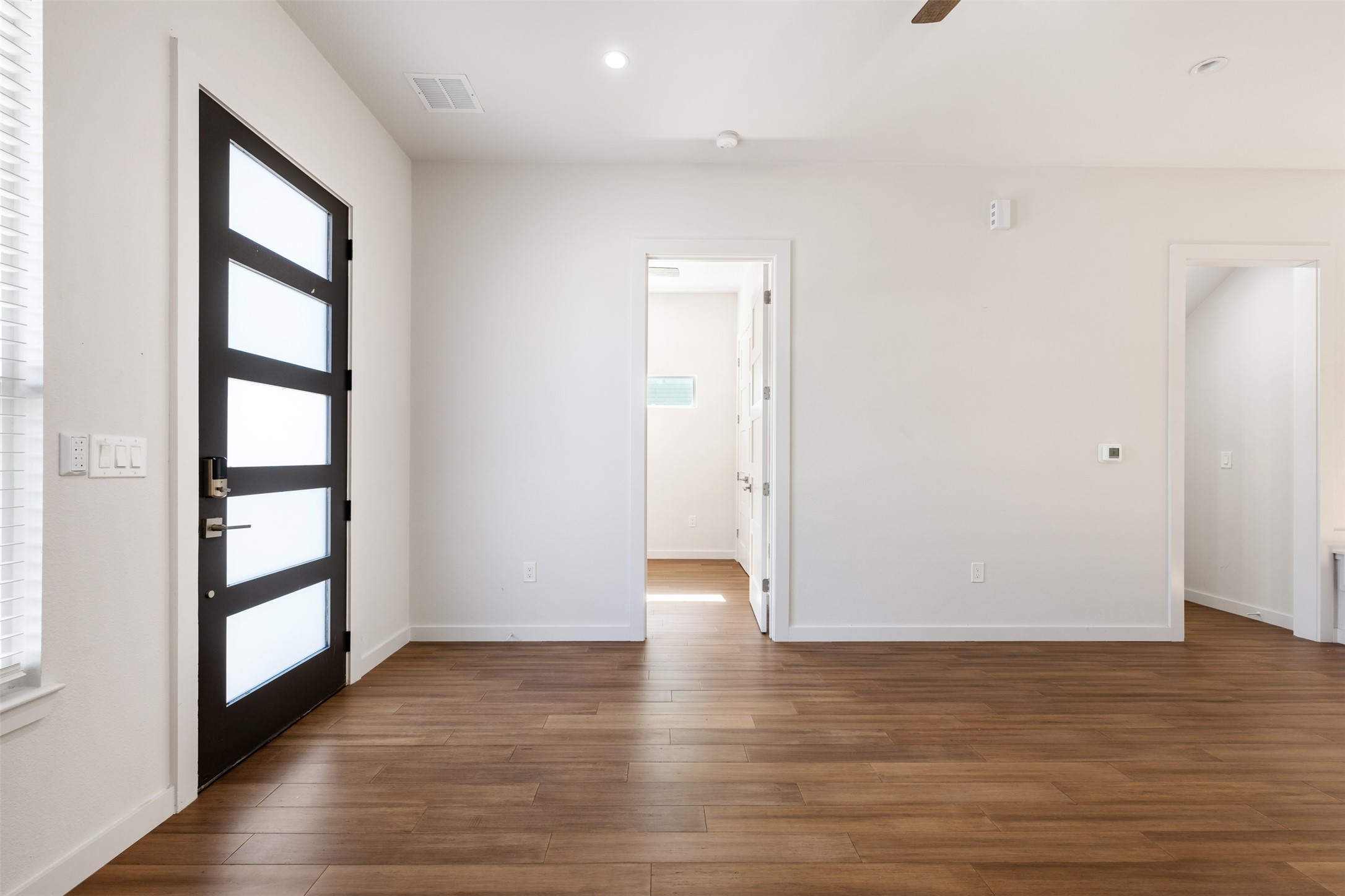 3010 Webberville Road, Unit 1 Austin, TX 78702 - Photo 14 of 38 an empty room with wooden floor and windows