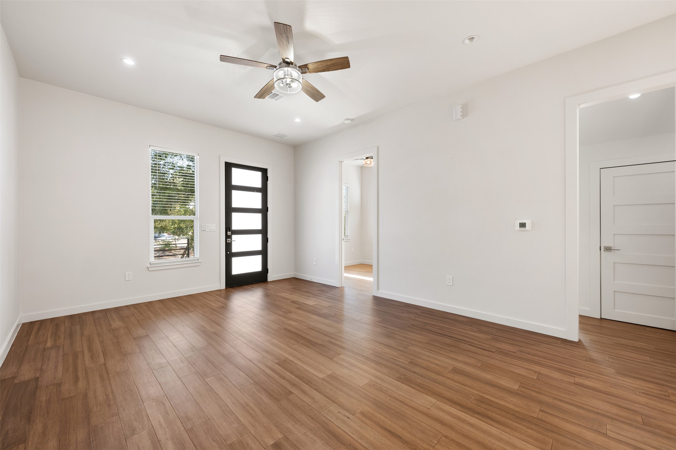 3010 Webberville Road, Unit 1 Austin, TX 78702 - Photo 18 of 38 a view of an empty room with a window and wooden floor