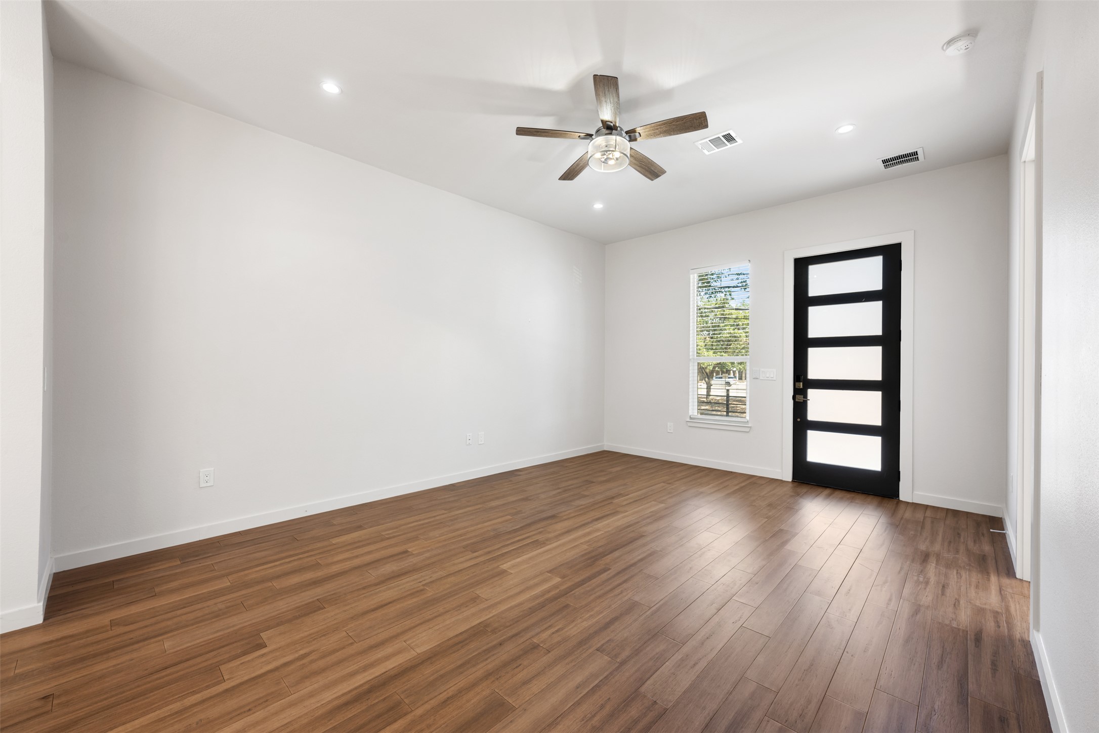 3010 Webberville Road, Unit 1 Austin, TX 78702 - Photo 20 of 38 a view of an empty room with wooden floor and a window