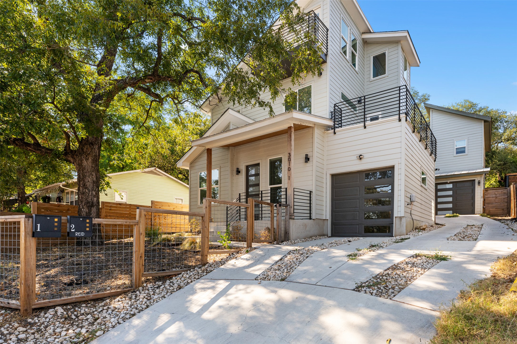 3010 Webberville Road, Unit 1 Austin, TX 78702 - Photo 5 of 38 Modern multi-level residence featuring light-colored siding and dark-framed windows