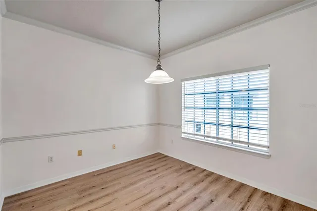 a view of a room with wooden floor and windows