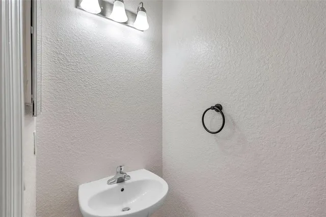 a bathroom with a sink and mirror
