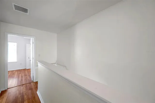 a view of hallway with wooden floor
