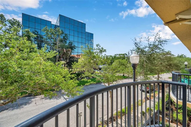 a view of a balcony with flower plants