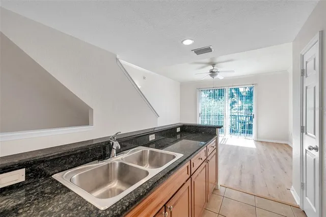 a kitchen that has a sink and cabinets