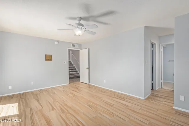 a view of an empty room with wooden floor