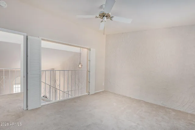 a view of empty room with ceiling fan