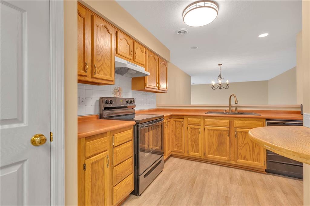 1217 Riverside Drive Beaver, PA 15009 - Photo 7 of 32 a kitchen with stainless steel appliances granite countertop a sink a stove cabinets and a dining table
