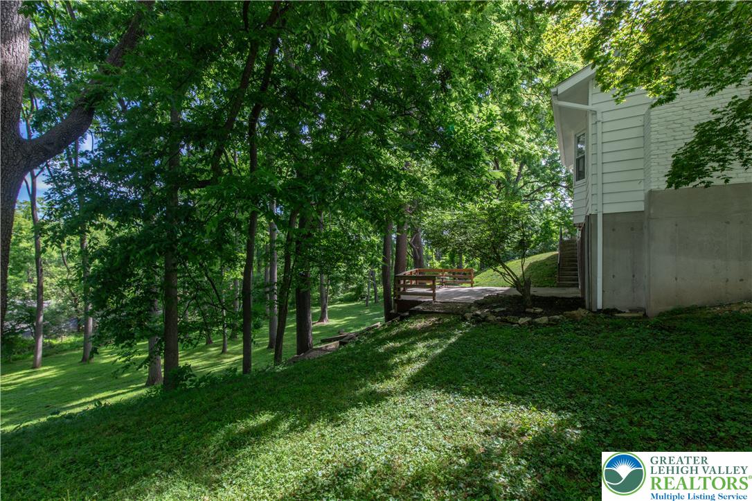 2011 Greenwood Road Allentown, PA 18103 - Photo 52 of 52 A tranquil outdoor patio blends seamlessly into a verdant, tree-lined landscape.