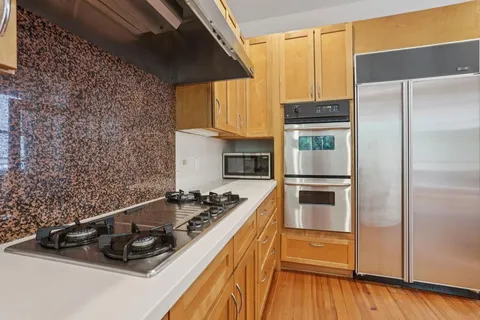a kitchen with a stove and a refrigerator