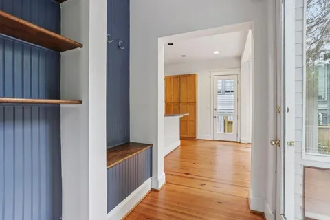 a view of a hallway with wooden floor