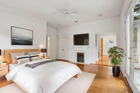 a spacious bedroom with a large bed and a flat screen tv