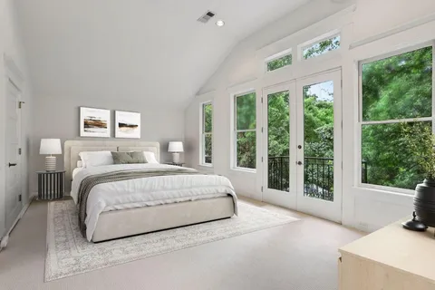 a spacious bedroom with a large bed and a large window