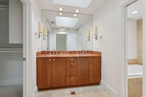 a bathroom with a double vanity sink and mirror