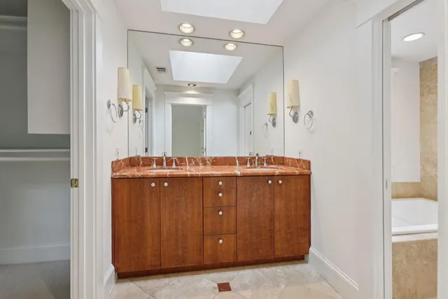 a bathroom with a double vanity sink and mirror