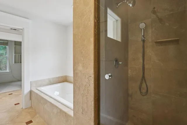 a bathroom with a granite countertop bathtub shower and sink