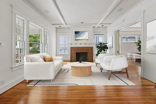 a living room with furniture a large window and a fireplace