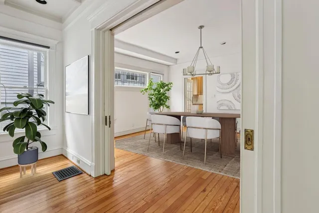 a view of a dining room with furniture window and wooden floor