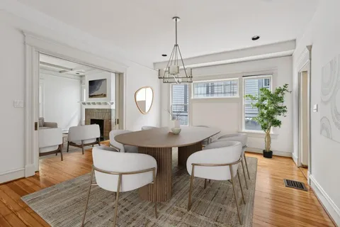 a living room with furniture a window and a table