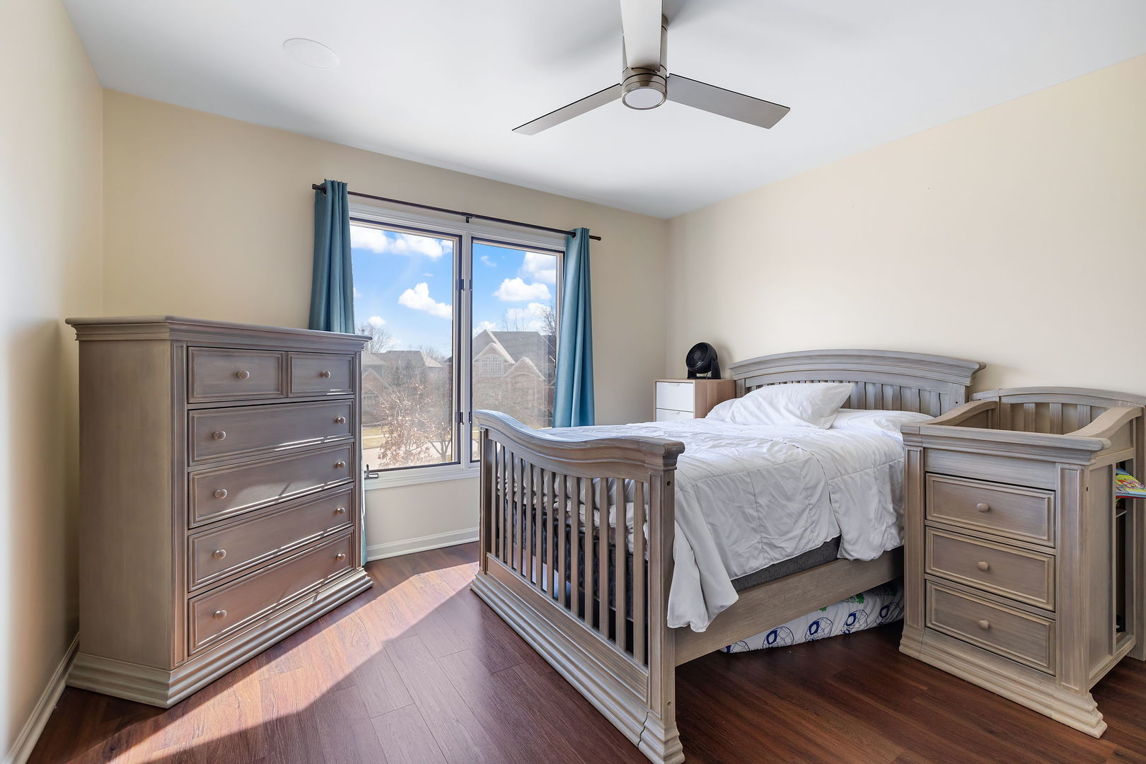 Undisclosed Address Aurora, IL 60502 - Photo 12 of 18 a bedroom with a bed and wooden floor