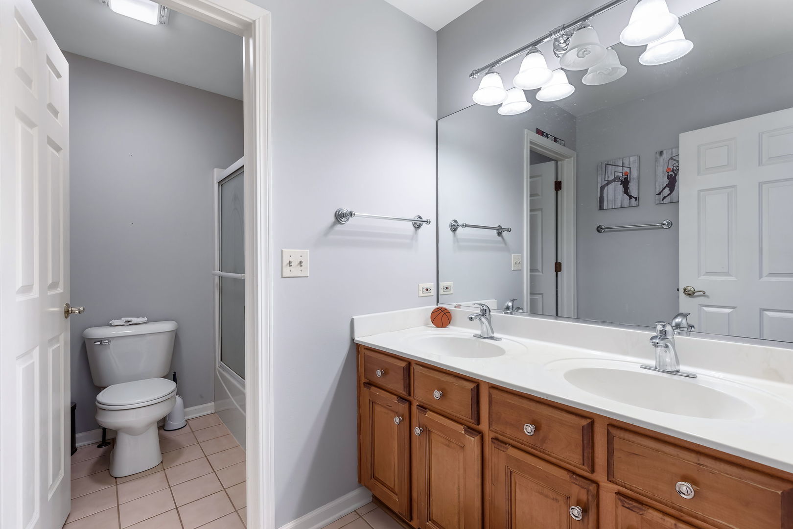 Undisclosed Address Aurora, IL 60502 - Photo 15 of 18 a bathroom with a toilet a sink and mirror